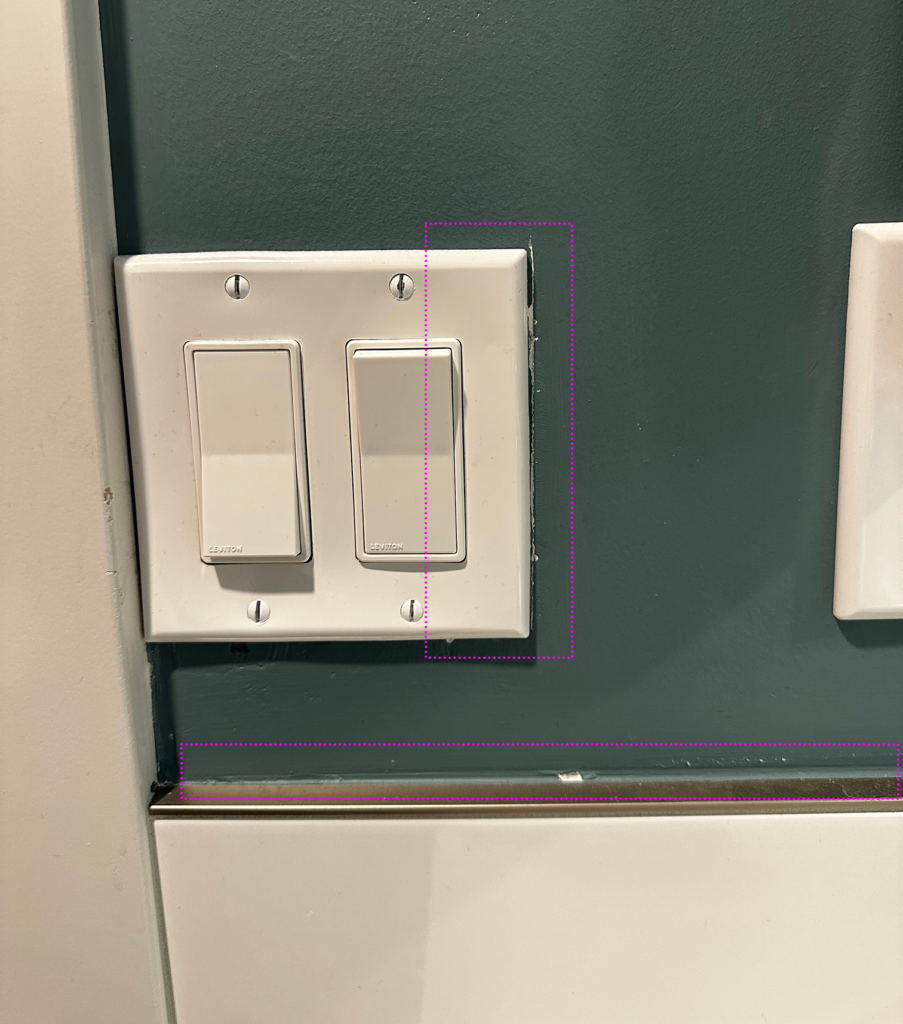 Scratches around light fixture and along schluter; paint over schluter around entire vanity