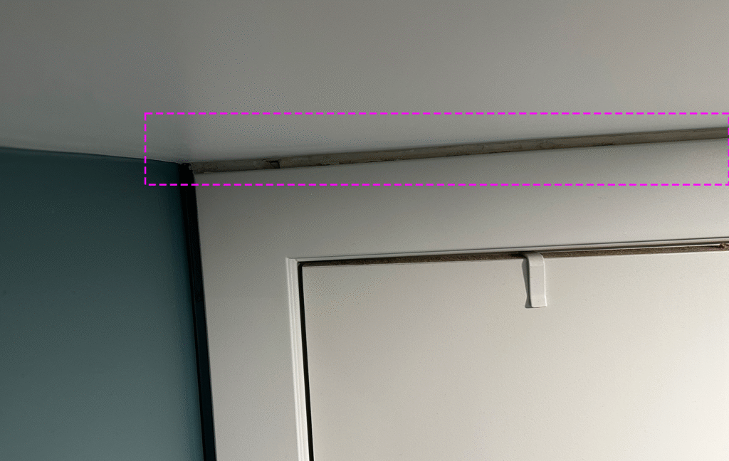 Old peeling yellow paint left above new door