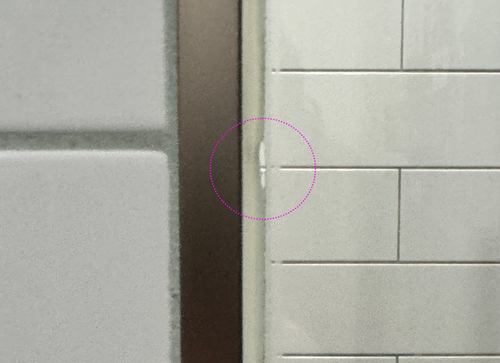 Gap in shower silicone along stub wall