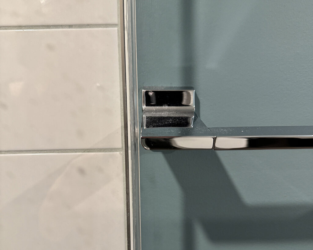 Towel bar millimetres from shower door