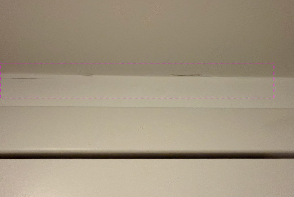 Cracked, peeling paint above the door